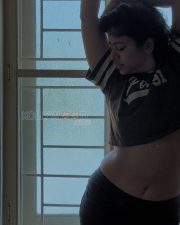 Stylish Actress Poonam Bajwa in a Brown varsity crop jersey Photos 04