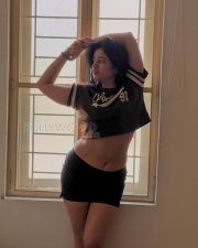 Stylish Actress Poonam Bajwa in a Brown varsity crop jersey Photos 05