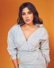 Actress Samyuktha Menon in a Light Wash Denim Shirt with a Deep V Neckline with a Matching Skirt Pictures 03