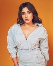 Actress Samyuktha Menon in a Light Wash Denim Shirt with a Deep V Neckline with a Matching Skirt Pictures 03