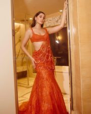 Sexy Nargis Fakhri in a Tangerine Orange Netted Drape Saree Photos 01