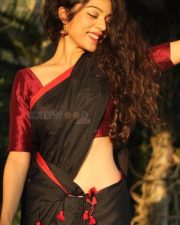 Sexy and Stunning Varsha Bollamma in a Black Saree with a Red Blouse Photos 02