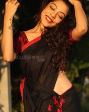 Sexy and Stunning Varsha Bollamma in a Black Saree with a Red Blouse Photos 03