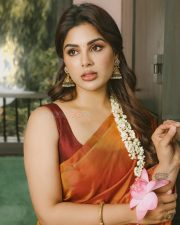 South Indian Actress Samyuktha Menon in an Orange Silk Saree with a Sleeveless Deep Maroon Blouse Photos 06