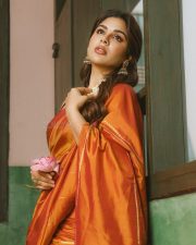 South Indian Actress Samyuktha Menon in an Orange Silk Saree with a Sleeveless Deep Maroon Blouse Photos 09