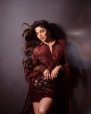 Glamorous Divya Bharathi in a Maroon Two Piece Outfit with a Button Down Shirt and Sequin Mini Skirt Photos 05