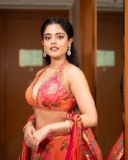 The RajaSaab Heroine Riddhi Kumar in an Orange Floral Lehenga Photos 10