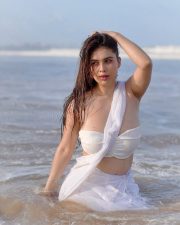 Bold Neha Malik in a White Saree at the Beach Photos 04