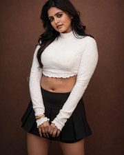 Fashionable Pragya Nayan in a White High Neck Long Sleeved Crop Top with a Black Pleated Mini Skirt Pictures 02