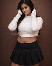 Fashionable Pragya Nayan in a White High Neck Long Sleeved Crop Top with a Black Pleated Mini Skirt Pictures 05