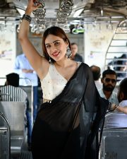 Sexy Neha Malik in a Black Saree and White Blouse in a Train Photos 04
