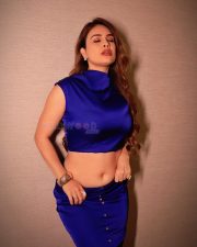 Sultry Actress Neha Malik in a dark navy blue high neck crop top with matching button up mini skirt photos 05