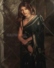 Timeless Actress Sreeleela in a Dark Green Silk Saree Photos 02