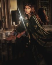 Timeless Actress Sreeleela in a Dark Green Silk Saree Photos 05