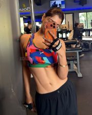 Actress Akanksha Puri in a Gym Mirror Selfie in a PUMA Multicolored Printed Sports Bra and Black Workout Bottoms Pictures 03