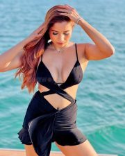 Alluring Actress Pooja Bhalekar in a Black Bikini Style Top with a Criss Cross Wrap and High Waisted Black Mini Skirt Pictures 06