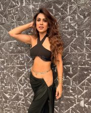 Attractive Nia Sharma in a Black Halter Neck Crop Top with a Matching High Waisted Black Flared Trousers Pictures 01