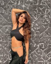 Attractive Nia Sharma in a Black Halter Neck Crop Top with a Matching High Waisted Black Flared Trousers Pictures 03