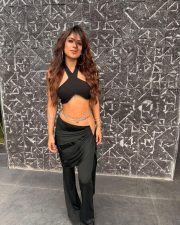 Attractive Nia Sharma in a Black Halter Neck Crop Top with a Matching High Waisted Black Flared Trousers Pictures 04