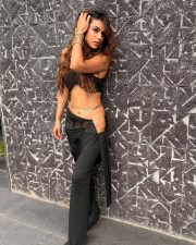Attractive Nia Sharma in a Black Halter Neck Crop Top with a Matching High Waisted Black Flared Trousers Pictures 05