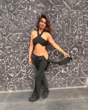 Attractive Nia Sharma in a Black Halter Neck Crop Top with a Matching High Waisted Black Flared Trousers Pictures 06