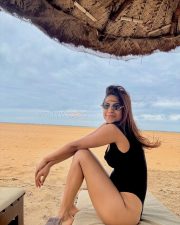Attractive Nia Sharma in a Black One Piece Swimsuit Pictures 01