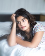 Divyansha Kaushik Lost in Thought on the Bed Photos 01