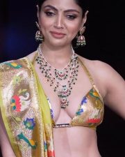 Glamorous Akanksha Puri Cleavage in a Gold Floral Halter Saree Photos 01