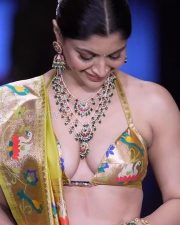 Glamorous Akanksha Puri Cleavage in a Gold Floral Halter Saree Photos 02