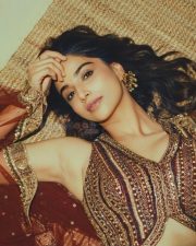 Actress Meenakshi Chaudhary in a Deep Forest Green Lehenga with an Embroidered Vest Style Crop Top Pictures 03