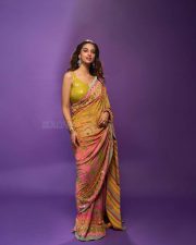 Actress Meenakshi Chaudhary in a Designer Sunset Orange Floral Embroidered Saree with a Contrasting Lime Yellow Sequin Blouse Pictures 04