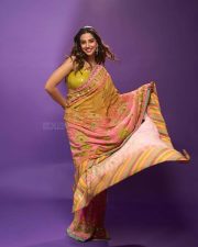 Actress Meenakshi Chaudhary in a Designer Sunset Orange Floral Embroidered Saree with a Contrasting Lime Yellow Sequin Blouse Pictures 05