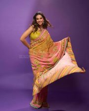 Actress Meenakshi Chaudhary in a Designer Sunset Orange Floral Embroidered Saree with a Contrasting Lime Yellow Sequin Blouse Pictures 05