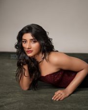Alluring Actress Mirnaa Menon in a Burgundy Lace Corset Top Photos 01