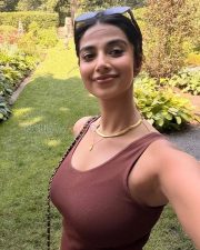 Carefree Actress Meenakshi Chaudhary in a Brown Ribbed Tank Top and Dark Shorts Photos 01