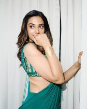 Charming Meenakshi Chaudhary in a Vibrant Emerald Green Pre Draped Chiffon Saree with a Matching Sleeveless Embellished Blouse Pictures 02