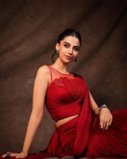 Glamorous Meenakshi Chaudhary in a Red Satin Lehenga Saree with a Embroidered Sheer Net Round Neck Photos 02