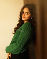Idhayam Murali Actress Kayadu Lohar in a Dark Green Ribbed Cardigan with a Black Mini Skirt Photos 02