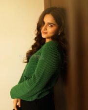 Idhayam Murali Actress Kayadu Lohar in a Dark Green Ribbed Cardigan with a Black Mini Skirt Photos 02