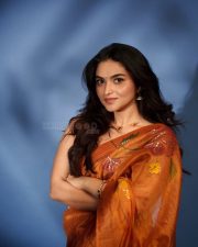 Radiant Actress Kayadu Lohar in a Orange Floral Printed Organza Saree Photos 02