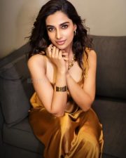 Stunning Glamour Beauty Meenakshi Chaudhary in a Golden Maxi Dress Photos 02