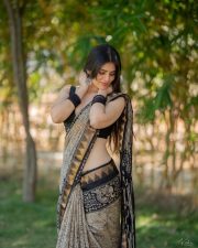 Telugu Actress and Model Bandhavi Sridhar in a Black and Gold Printed Saree with a Black Sleeveless Blouse Photos 07
