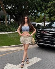 Captivating Actress Giorgia Andriani in a Blue Gingham Bandeau Crop Top and Beige Ruffle Mini Skirt Photos 04