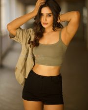 Glamorous Vithaikkaaran Actress Anaira Gupta in an Olive Green Tank Top with a Light Khaki Short Sleeved Shirt and Black High Waisted Shorts Photos 02