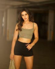 Glamorous Vithaikkaaran Actress Anaira Gupta in an Olive Green Tank Top with a Light Khaki Short Sleeved Shirt and Black High Waisted Shorts Photos 06