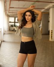 Glamorous Vithaikkaaran Actress Anaira Gupta in an Olive Green Tank Top with a Light Khaki Short Sleeved Shirt and Black High Waisted Shorts Photos 07