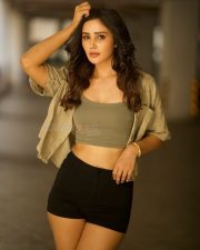Glamorous Vithaikkaaran Actress Anaira Gupta in an Olive Green Tank Top with a Light Khaki Short Sleeved Shirt and Black High Waisted Shorts Photos 08