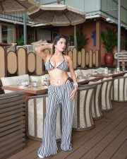 Striking Actress Kate Sharma in a Black White Striped Bikini Top and Wide Leg Pants Photos 01
