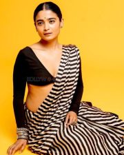 3BHK Actress Chaithra J Achar in a Striped Black and White Saree with a Deep Cut Long Sleeve Blouse Photos 05