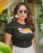 Actress Aanchal Munjal in a Hottie Tshirt and White Mini Skirt Photos 01